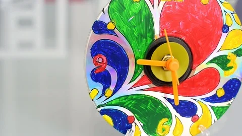 Clock painted by hand - a brilliant circle similar to a computer disk Stock Footage 108109018