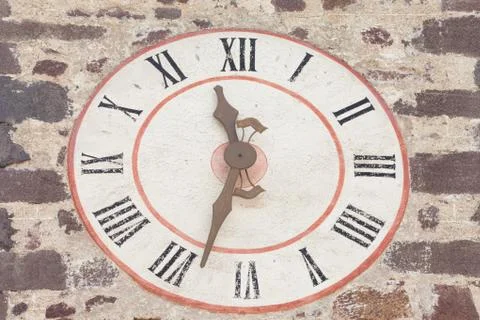 The clock painted outside the bell tower of the church in St. Magdalena di Va Stock Photos