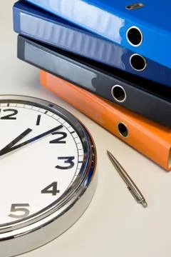 The clock, pen and binders Stock Photos