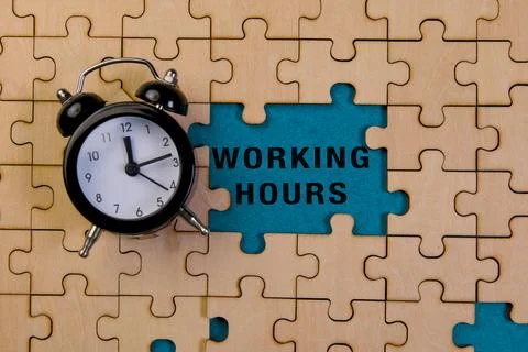 Clock on puzzle piece emphasizing working hours concept Stock Photos