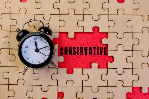 Clock on puzzle pieces with conservative message Stock Photos