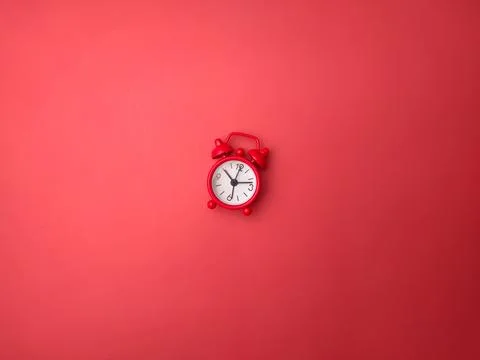 Clock on a red background. Background and texture concept. Stock Photos