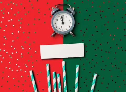 Clock is on a red background with green stripes Foto stock