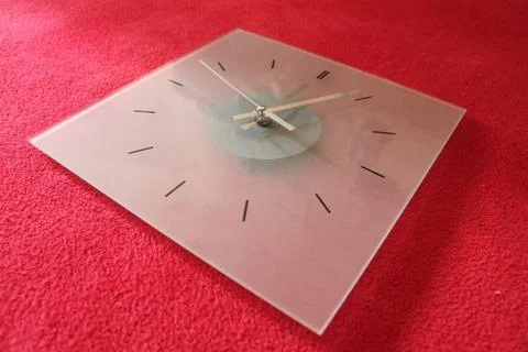 The clock on red background Stock Photos