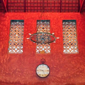 Clock on red sculture texture wall Stock Photos