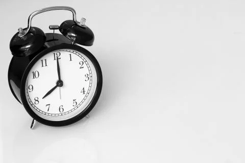 Clock retro at 8 o'clock on white table background with space for text. Stock Photos
