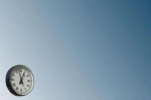 Clock with Roman numerals on blue gray.Place for text Stock Illustration