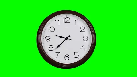 Clock with a round dial against a green screen. Time concept. The hands make  Stock Footage 95117414