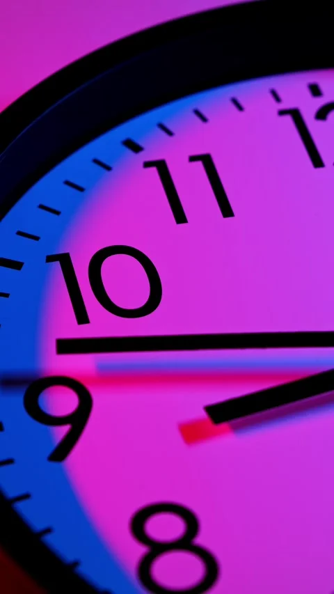 Clock running fast. Time lapse of classic wall clock in blue and red lights. Stock Footage 295438208