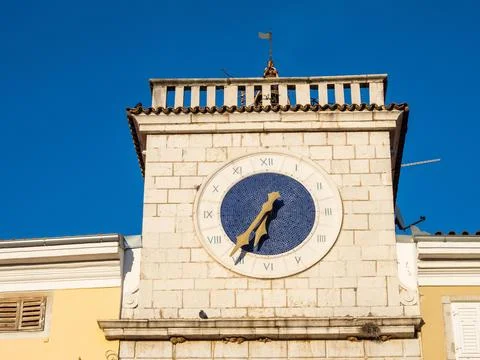 Clock at the sea gate in the evening light Cres Town Cres Island Kvarner Gulf Stock Photos