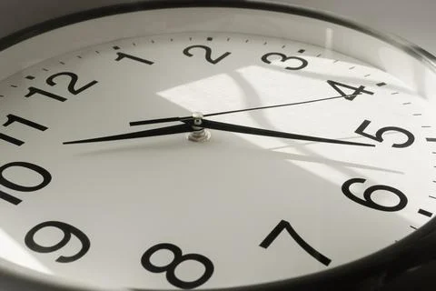 Clock With Second, Minute and Hour Hands With Sun Flare Reflection Stock Photos