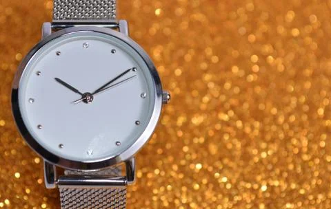 Clock on a shiny yellow background. Stock Photos