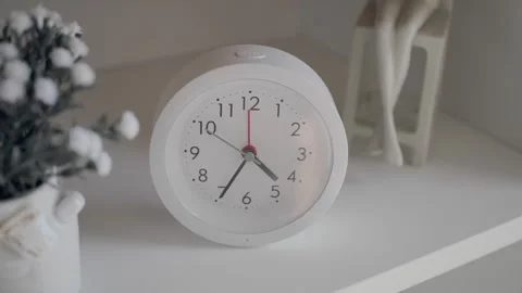 Clock showing time on a shelf with decorations Stock Footage 344098691