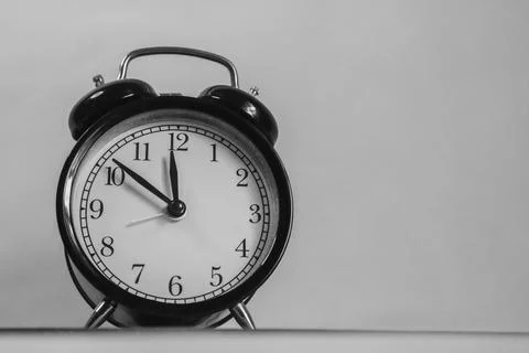 The clock shows 12 o'clock; it's lunchtime Stock Photos
