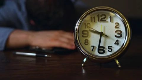 The clock shows half past nine in the evening. Man fell asleep at work. Stock Footage 144783553