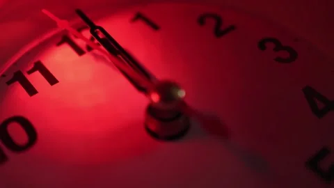 The clock shows the time 00:00. Midnight. Red light. Time passes. Close-up. Stock Footage 250027043