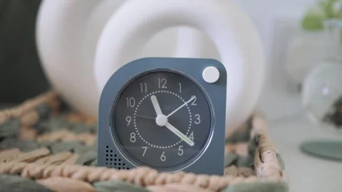 Clock shows time in home setting with green decor 動画素材 342303820