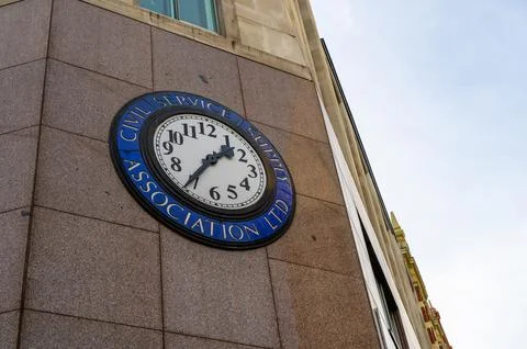 Clock on side of building on corner of The Strand and Bedford Street, WC2, Lo Stock Photos