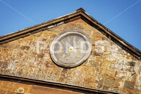 Clock on the stable wall, reading 2.30 pm Stock Photos