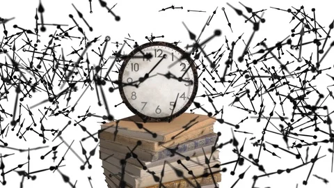 The clock standing on stack of old books, and they fly around the clock Video stock 96078423