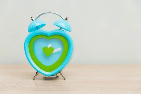 Clock standing on a wooden background Stock Photos