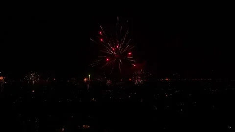 Clock strikes midnight on New Years Eve 2023, sky erupts from fireworks Stock Footage 261152130