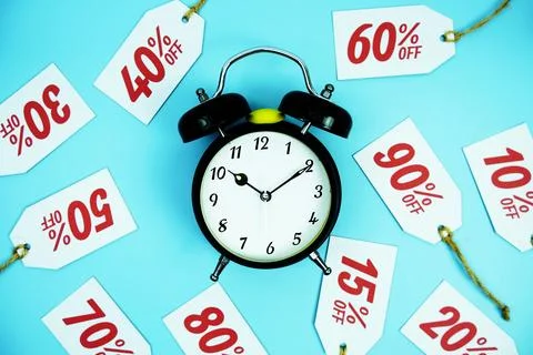 Clock surrounded by various discount tags with percentages like 10%, 20%, 3.. Foto stock