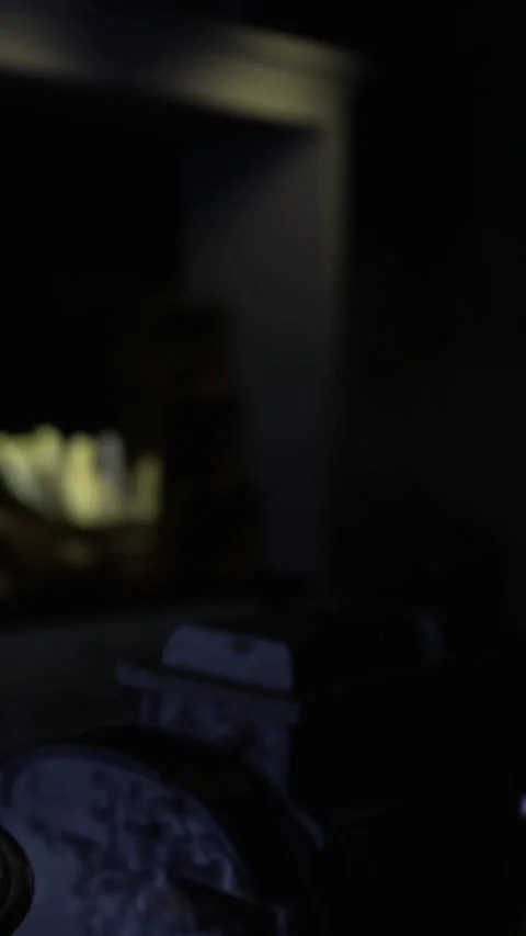 Clock on a table in a dark room with light in the background during the evening Stock Footage 331662520
