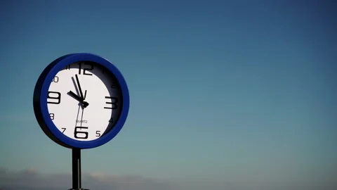 Clock ticking against blue sky. Holidays Stock Footage 127450155