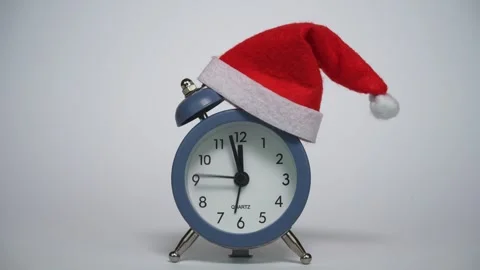 Clock ticking before the New Year. Isolated  alarm clock with Santas hat Stock Footage 315412976
