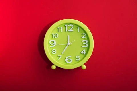 Clock time on a red bright background Stock Photos