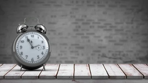 Clock on top of a wooden table Stock Footage 107610595