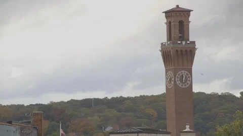 Clock tower, American flag, fall foliage Stock Footage 304373008