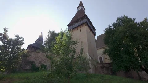 Clock tower and historic walls of Biertan fortified church in Transylvania Stock Footage 346519520