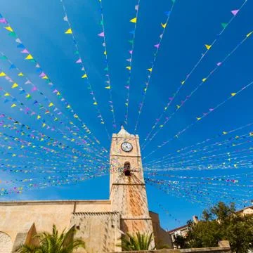 Clock tower, and holiday flags in a small town Stock Photos