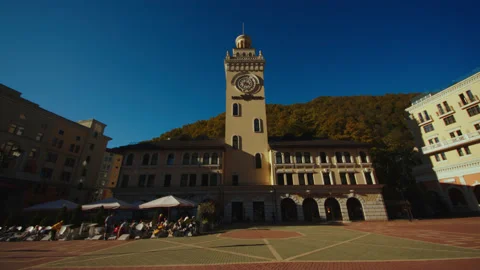 Clock tower and hotels against the clear sky background and forested caucasian Stock Footage 204049237