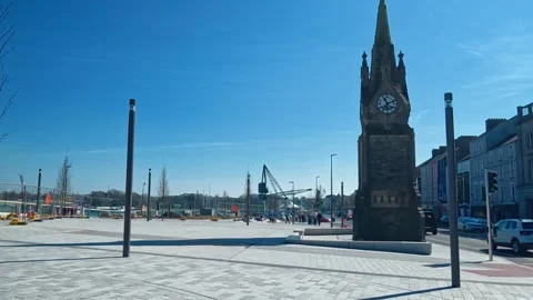 Clock tower and new plaza on city quays in Waterford Ireland early on a summer Stock Footage 333392967