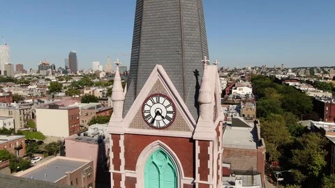 Clock tower of a brick church above Brooklyn rooftops Stock-Footage 115053320