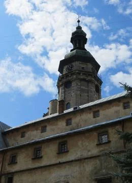 Clock tower of the cathedral on a background of blue sky with clouds. Berna.. Stock Photos