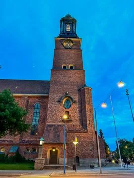 A clock tower in front of a brick building of Eskilstuna in Sweden. Stock Photos