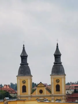 A clock tower in front of a building in Eger Stock Photos