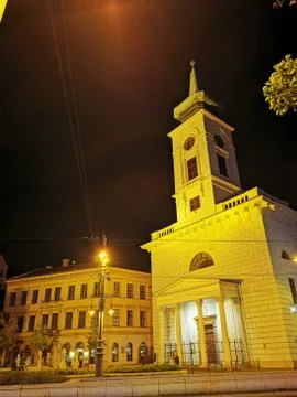 A clock tower in front of a building Stock Photos