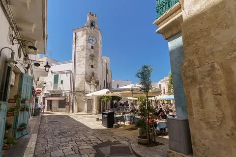 Clock tower in Garibaldi square. Civic tower in the historic center of Monopoli Stock Photos