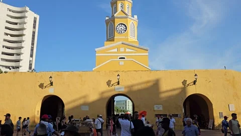 Clock Tower Gate Arches and Crowd Under Blue Sky, Cartagena, Colombia 8K Stock-Footage 331499259