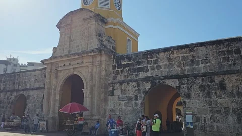 Clock Tower Gate With Sun Burst and Vendor Umbrella, Cartagena, Colombia 8K Stock Footage 331501197