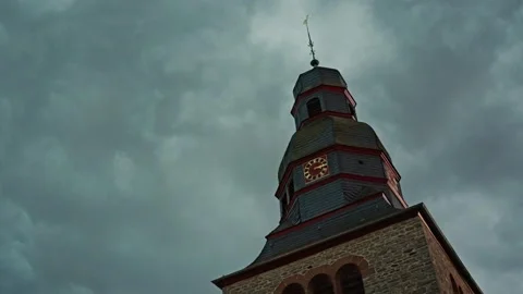 The clock tower, a historic landmark, is set against a dramatic sky, creating a Stock Footage 303597647