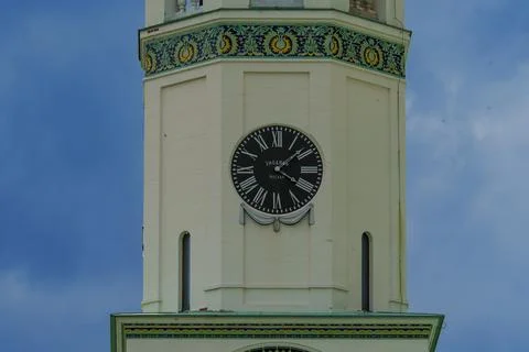 Clock tower with ornate decorations under blue sky Stock Photos