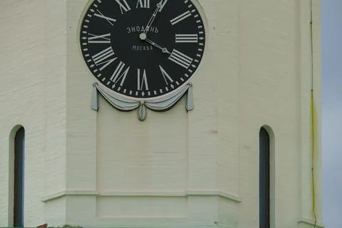 Clock tower with roman numerals and decorative elements Stock Photos