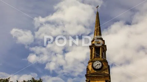 Clock tower with ship weather vane. Stock Photos