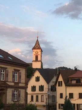 Clock tower at sunset in a quaint German town Stock Photos